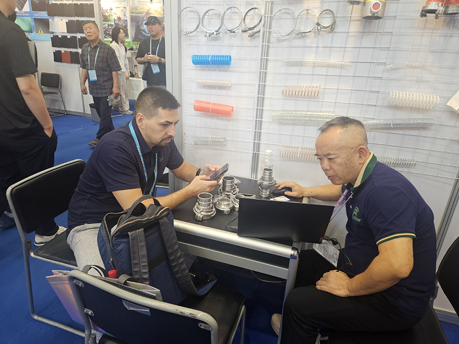 Discussing coupling specifications with a buyer at the booth